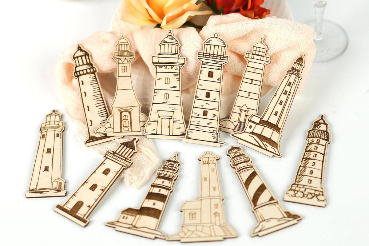 a collection of wooden lighthouse cutouts arranged on a white surface.
