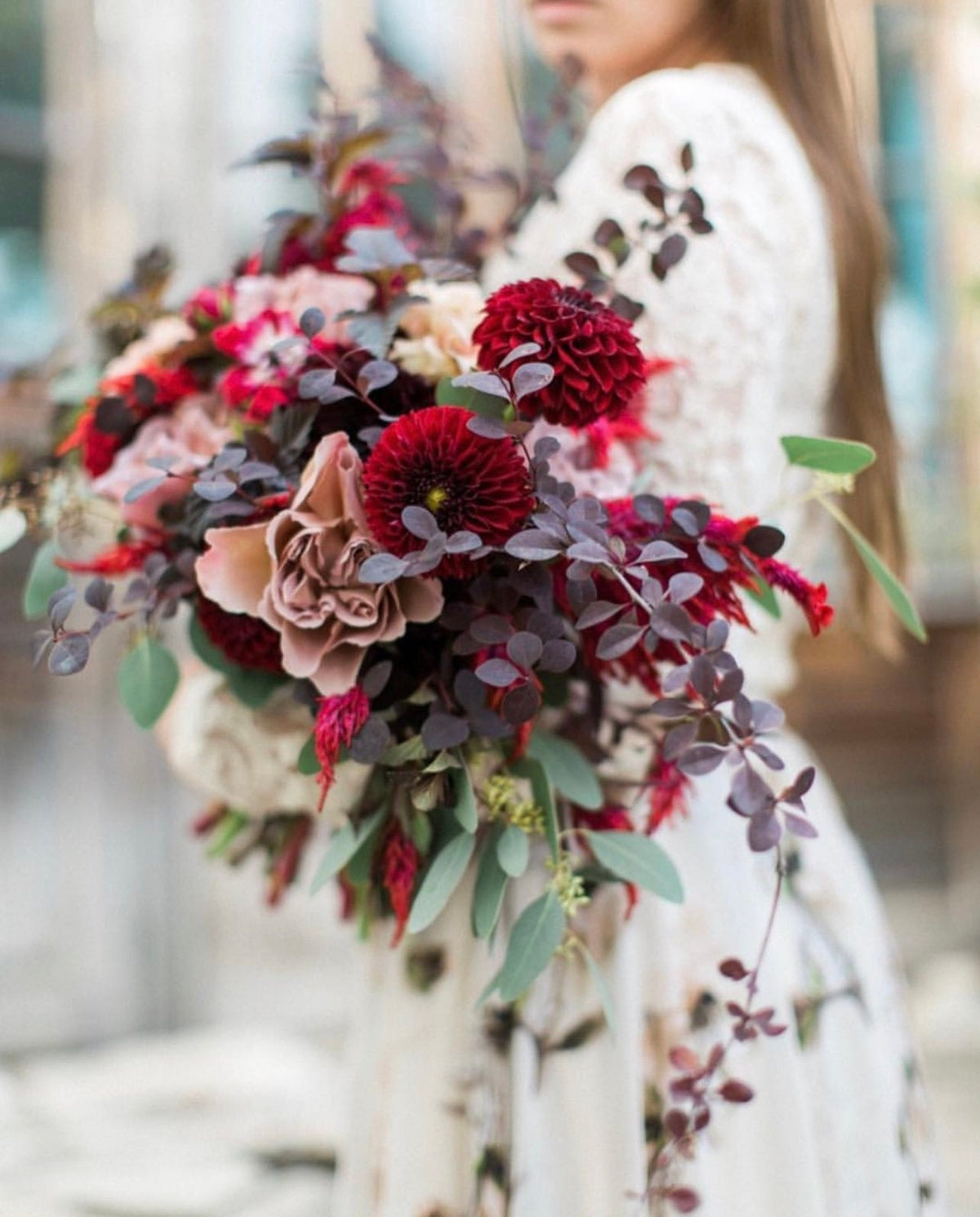 a woman is holding a bouquet of flowers