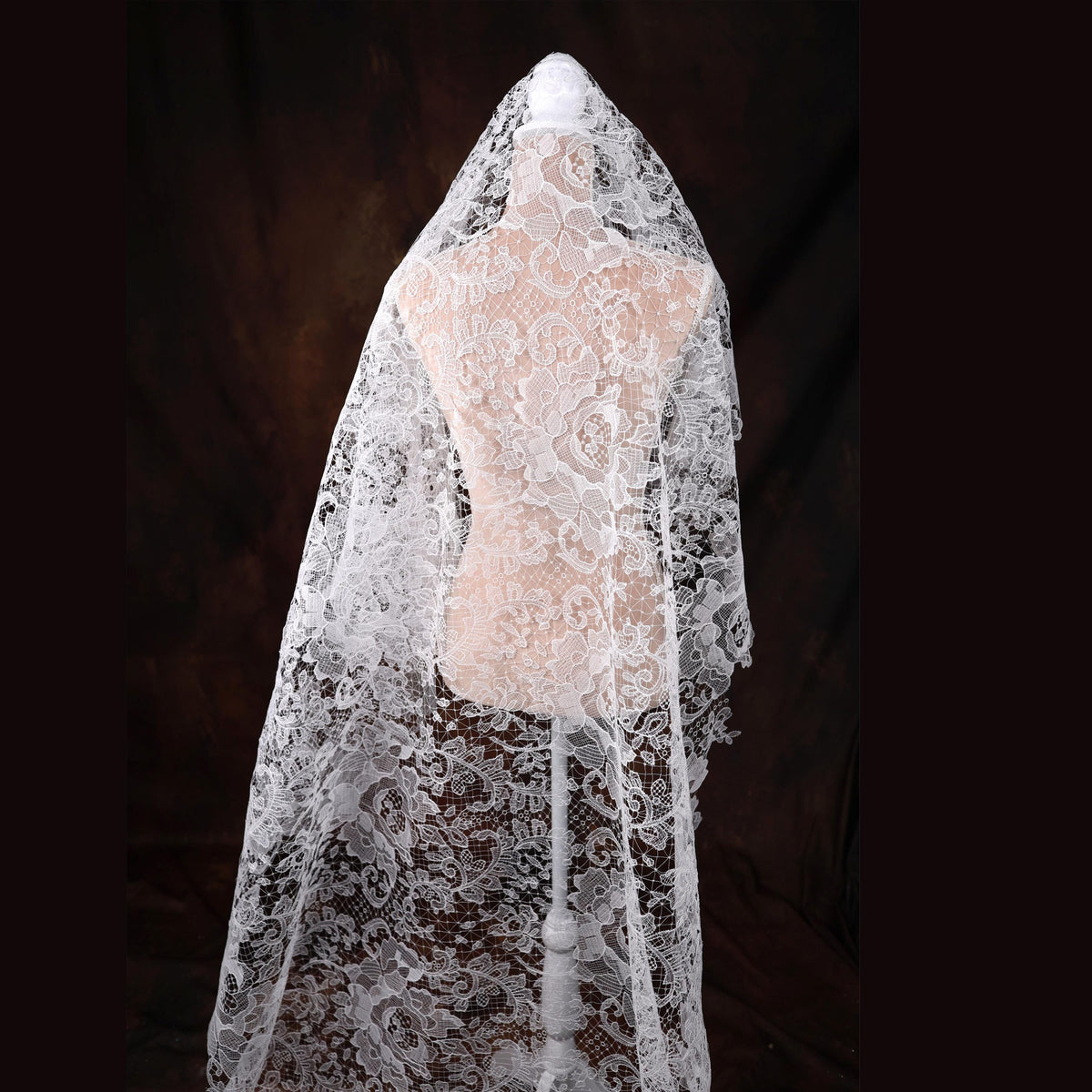 a mannequin is covered with a white veil