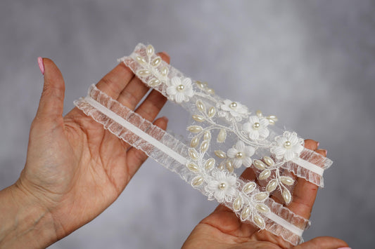 a pair of hands holding a piece of lace