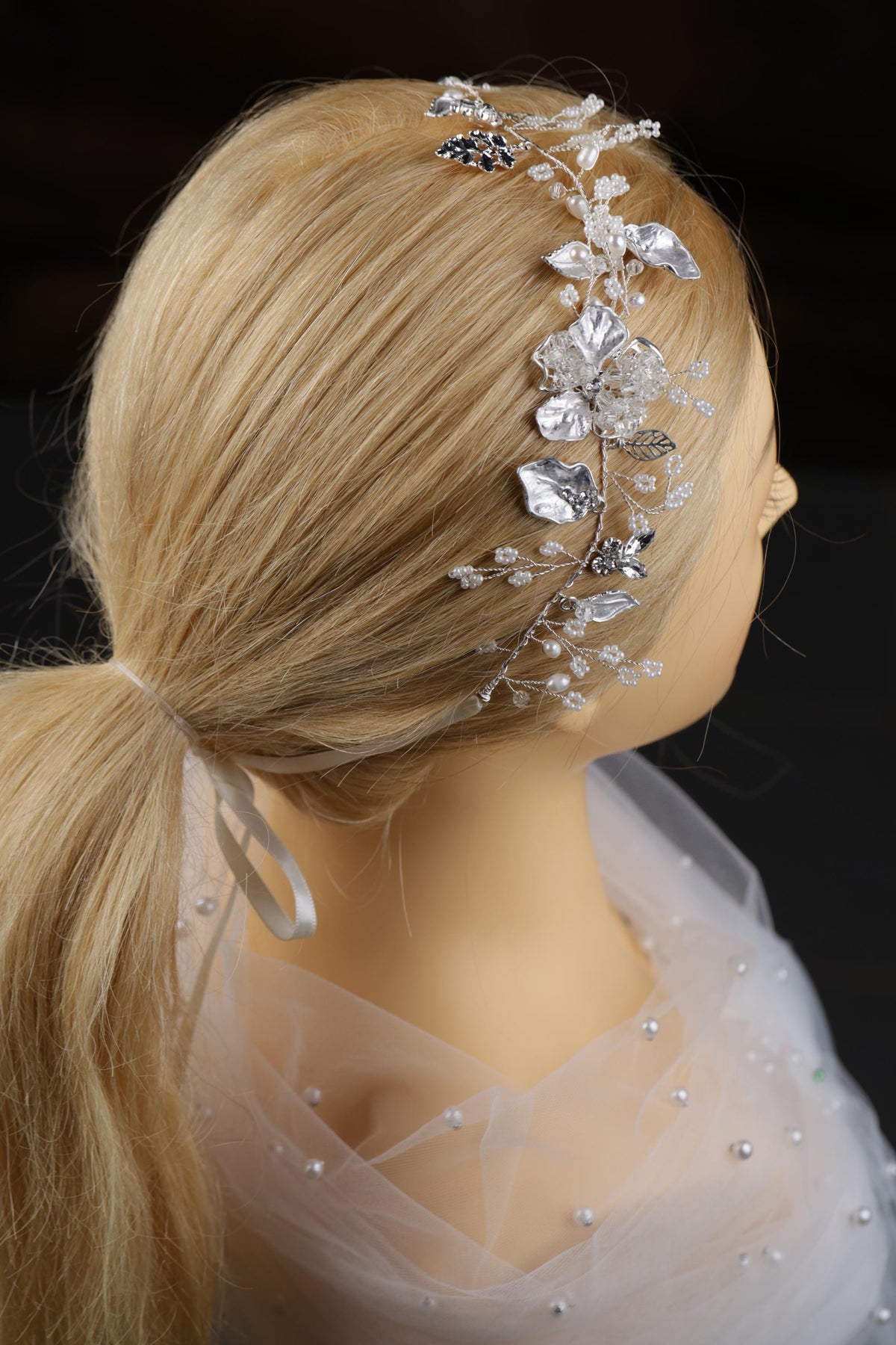 a close up of a mannequin wearing a headpiece