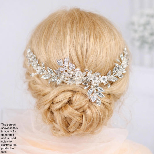 the back view of a woman's blonde hair with a decorative hair accessory, which appears to be a floral or leaf-shaped piece.