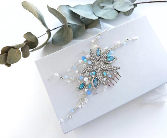 a white box with a blue and white brooch on it