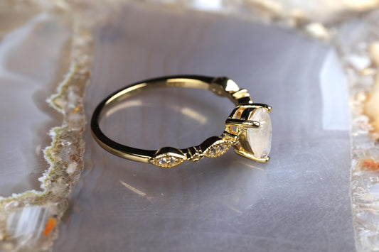 a diamond ring sitting on top of a rock