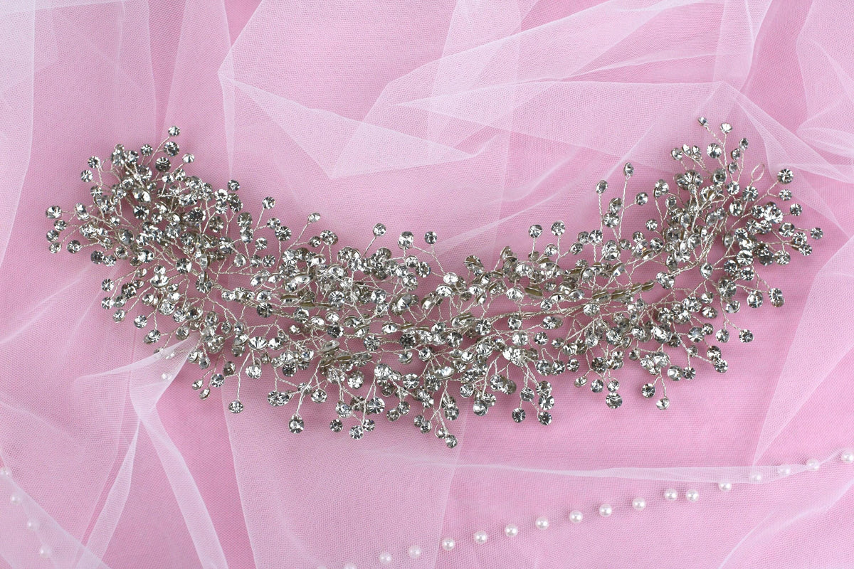 a close up of a necklace on a pink background