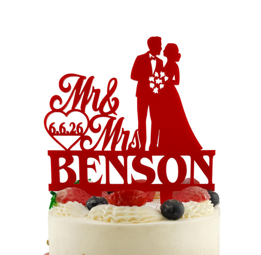 A red wedding cake topper with the names 'Mr. and Mrs. Benson' written on it.