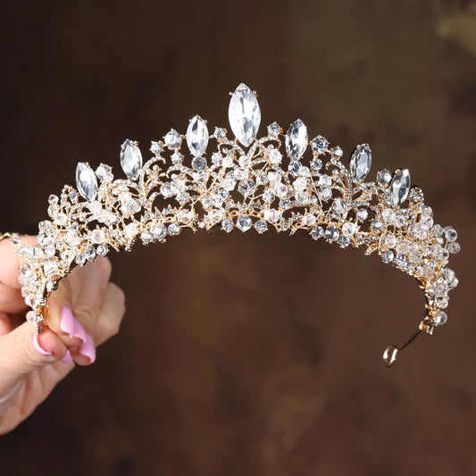 a close up of a person holding a tiara
