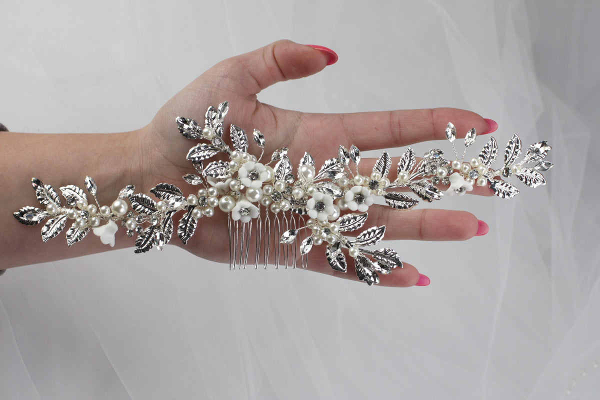 a woman's hand holding a bridal hair comb