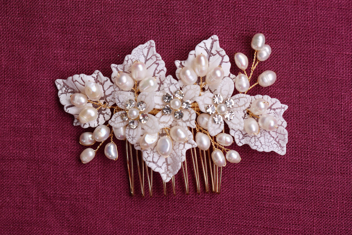 a close up of a hair comb with flowers and pearls