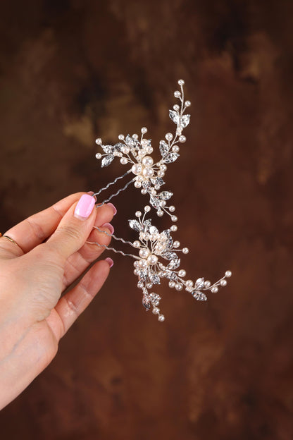 a woman holding a bridal hair comb in her hand