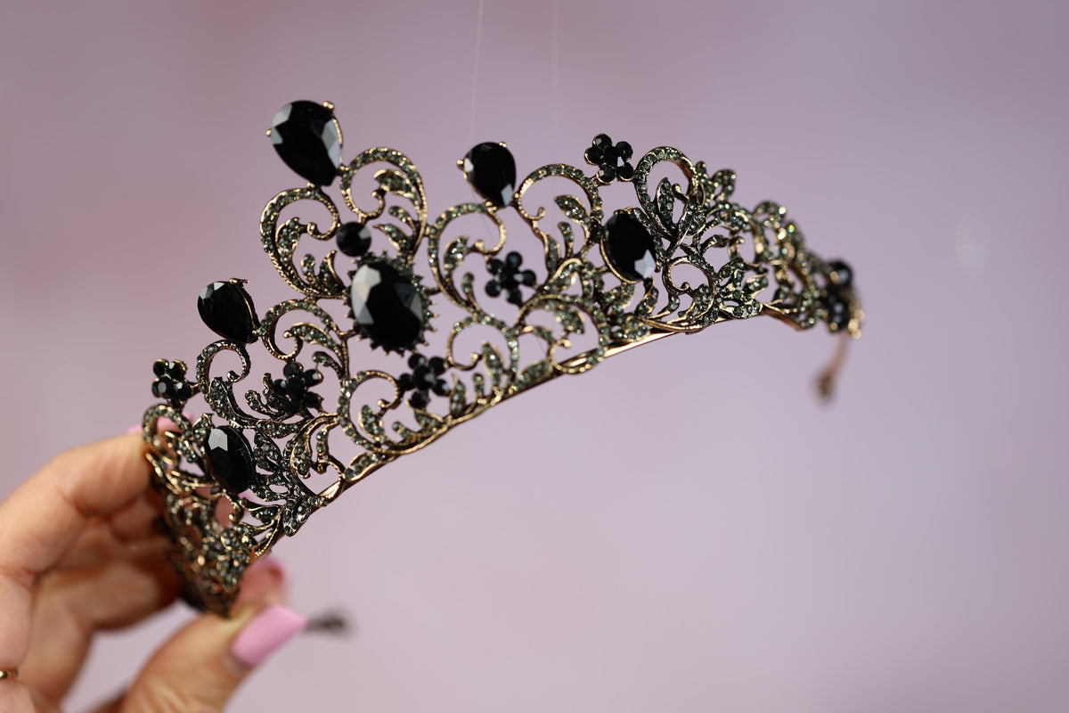 a woman holding a tiara in her hand