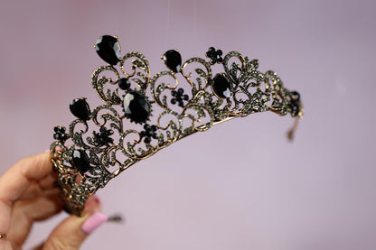 a woman holding a tiara in her hand