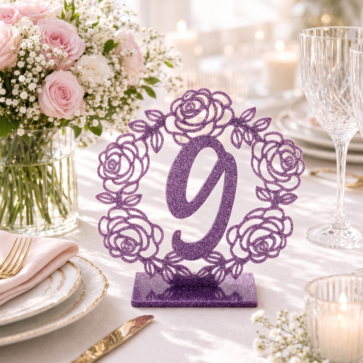 a table setting with a purple table number 9 holder, a vase of pink roses, and other tableware such as plates, a fork, a knife, and a wine glass.