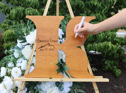 a person writing on a wooden easel with flowers in the background