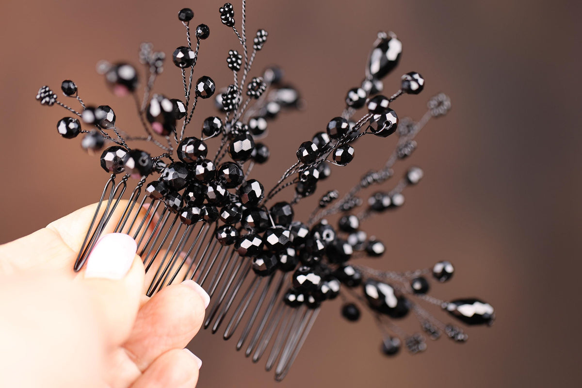a person holding a comb with black beads on it