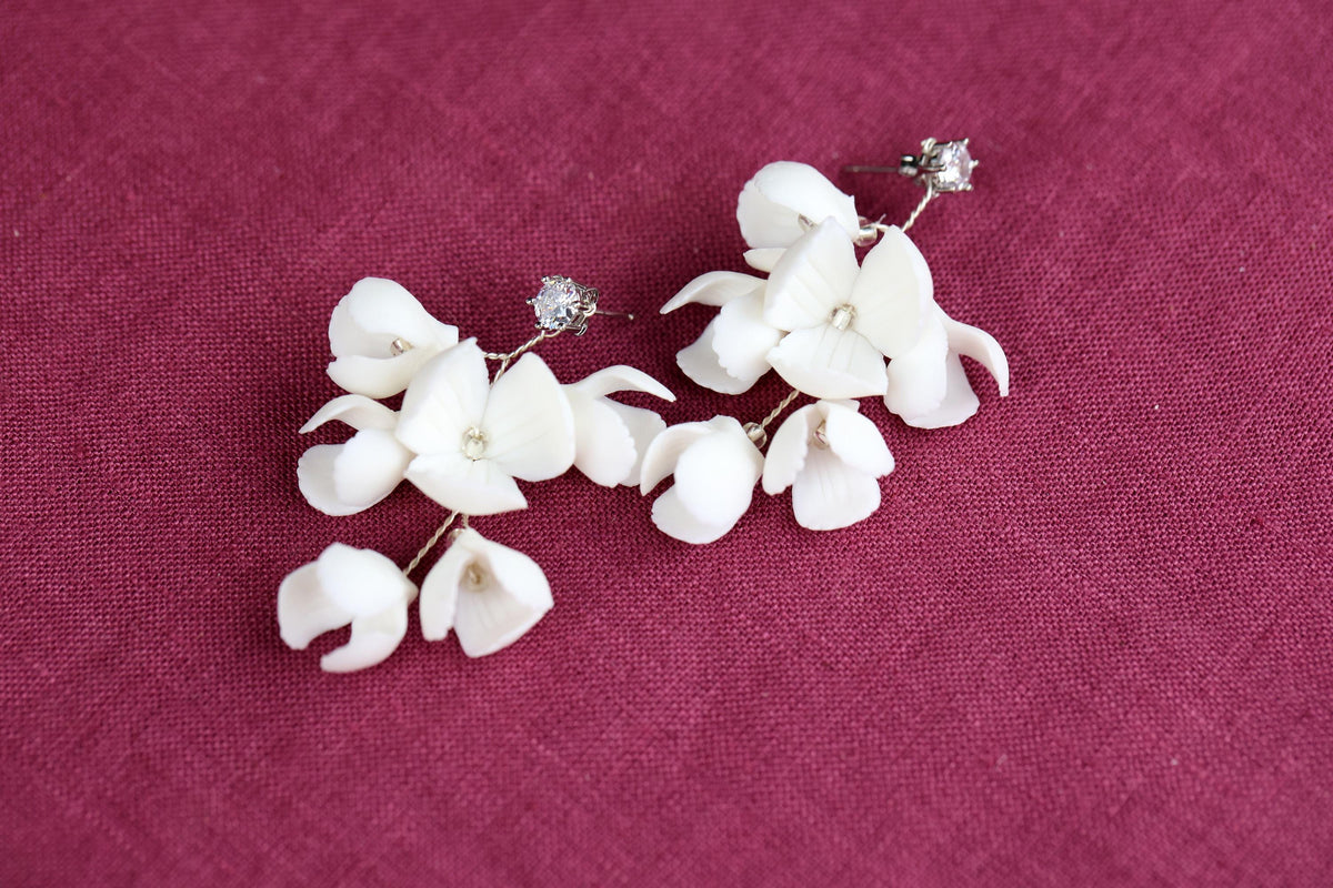 a pair of white flowers on a purple surface