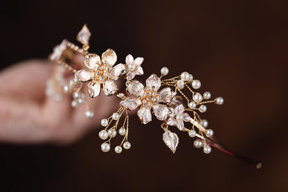 a close up of a person holding a piece of jewelry