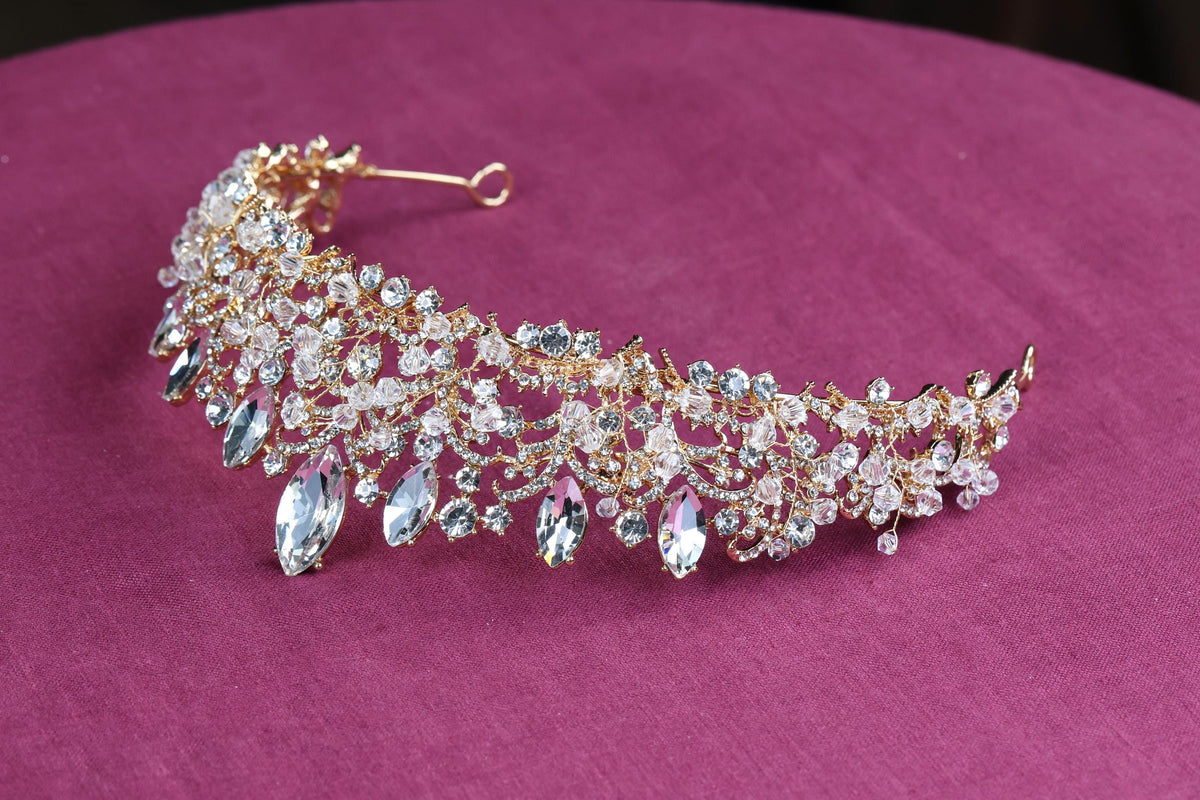 a close up of a tiara on a pink surface
