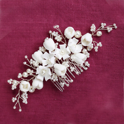 a bridal hair comb with white flowers and pearls