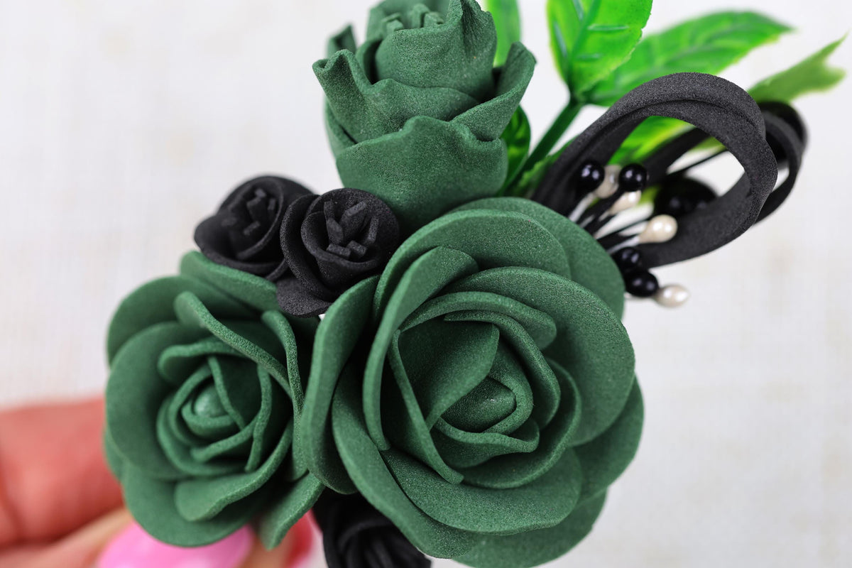 a close up of a person holding a fake flower