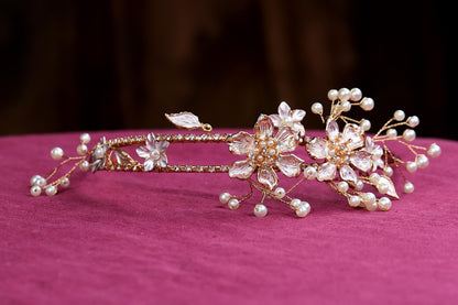 a close up of a tiara on a pink surface