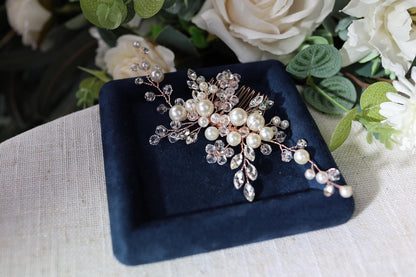 a close up of a brooch with flowers in the background