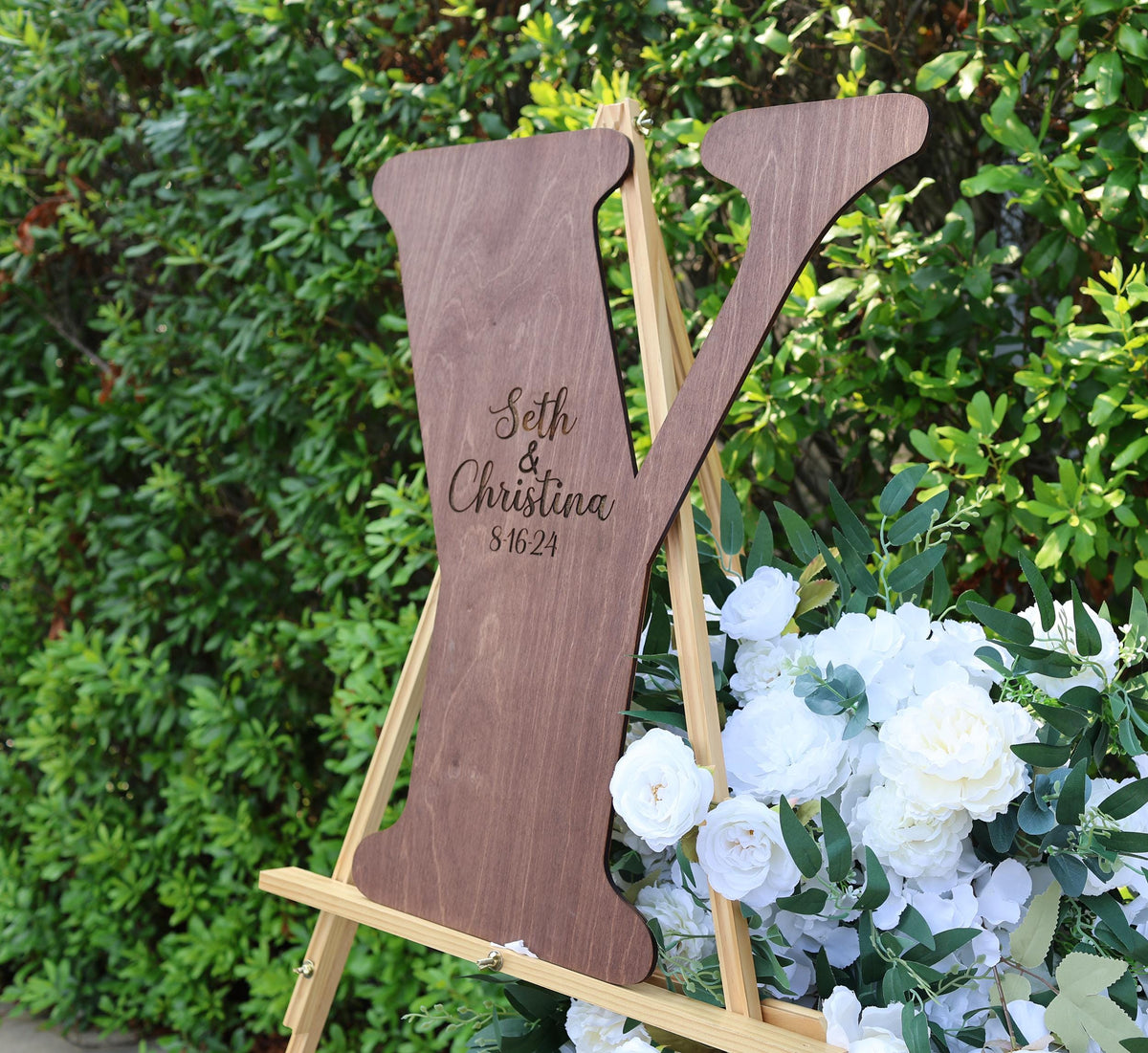 a wooden sign sitting on top of a wooden easel