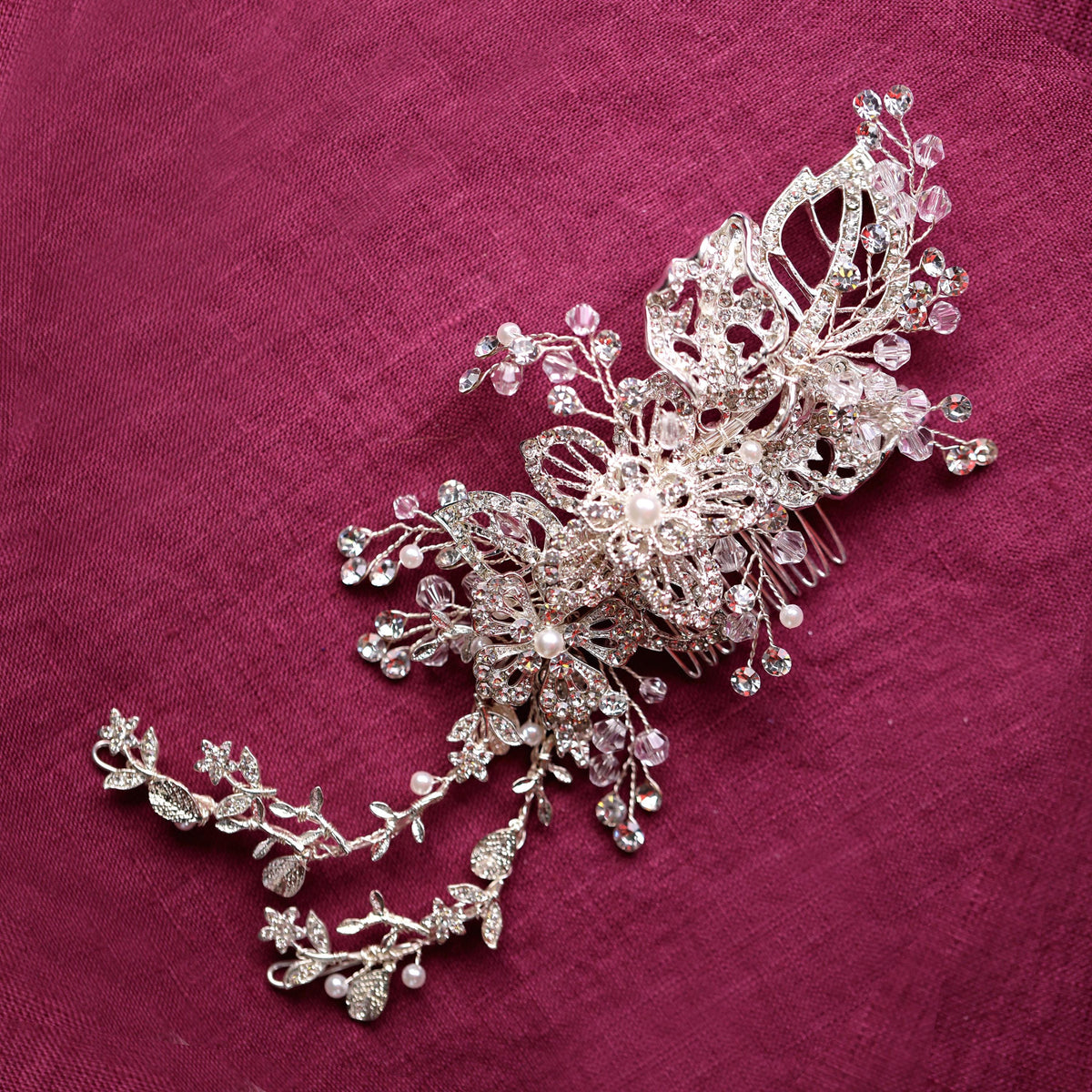 a close up of a brooch on a pink cloth