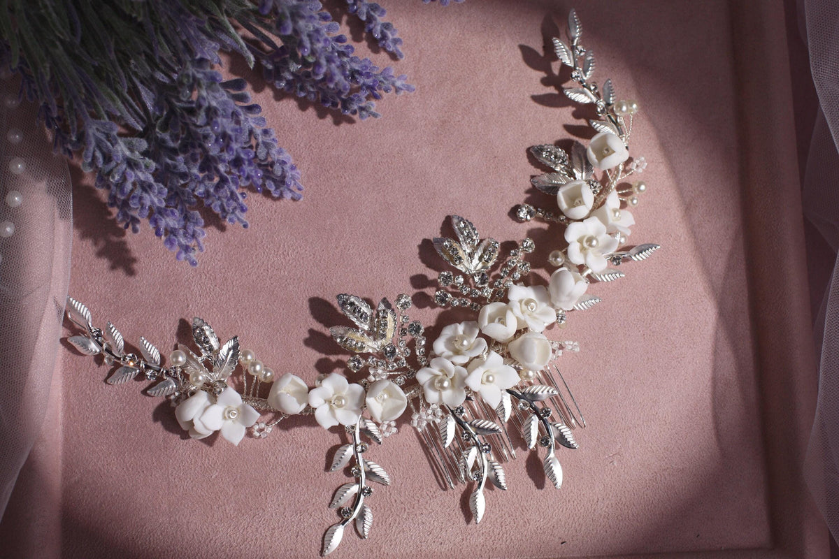 a close up of a necklace with flowers on it