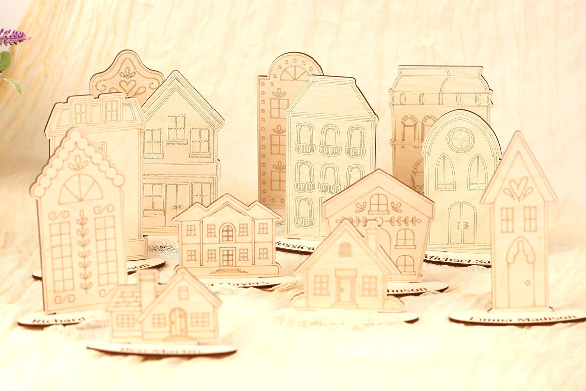 a collection of wooden houses or buildings, each with unique architectural designs and details, arranged on a surface.