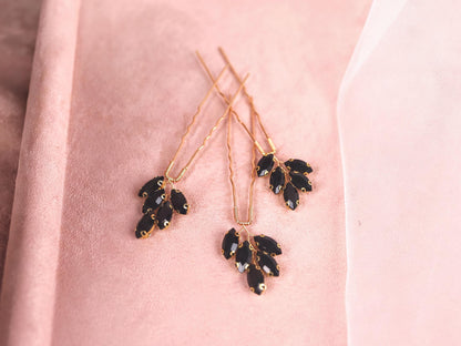 a close up of a pair of earrings on a pink cloth