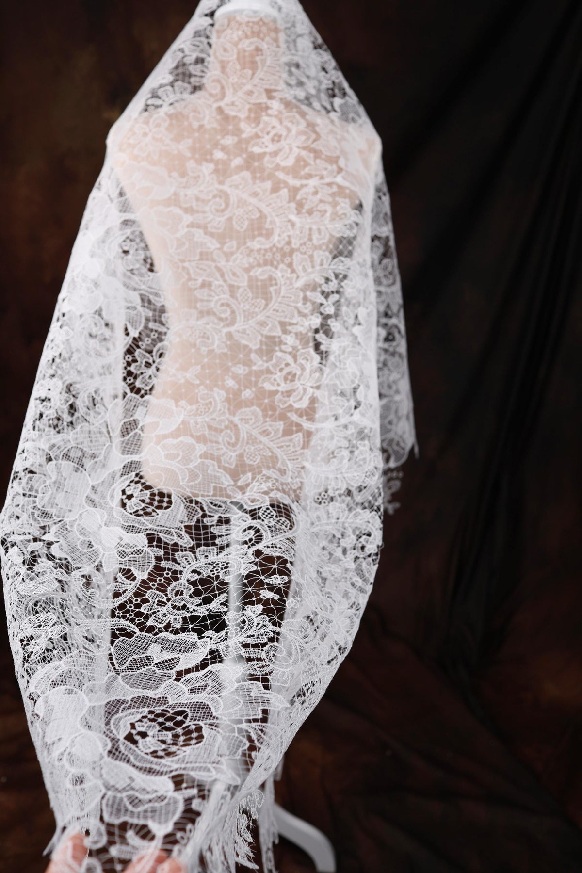 a woman wearing a white veil and a white dress