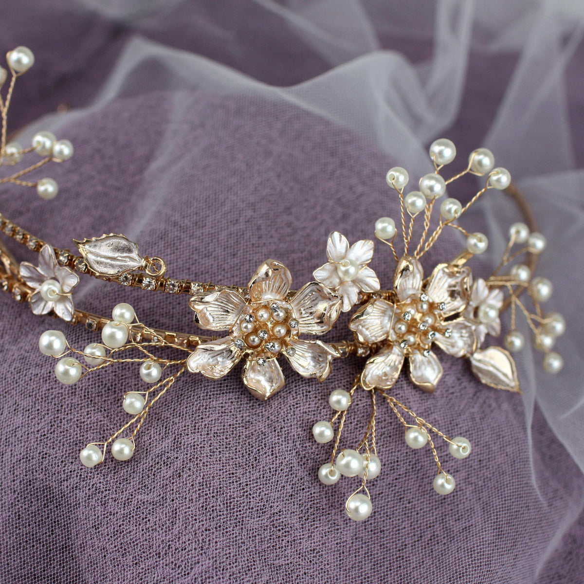 a close up of a tiara with pearls