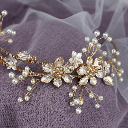 a close up of a tiara with pearls