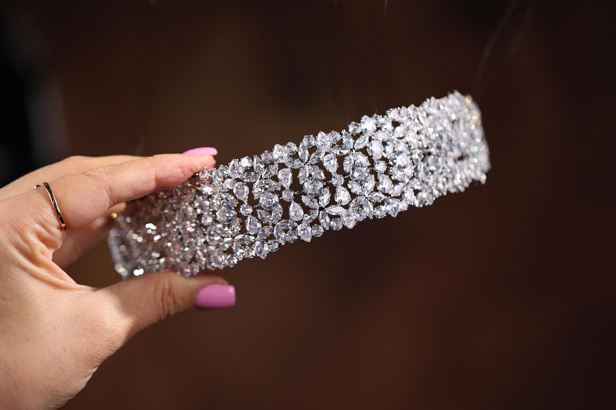 a woman's hand holding a diamond bracelet