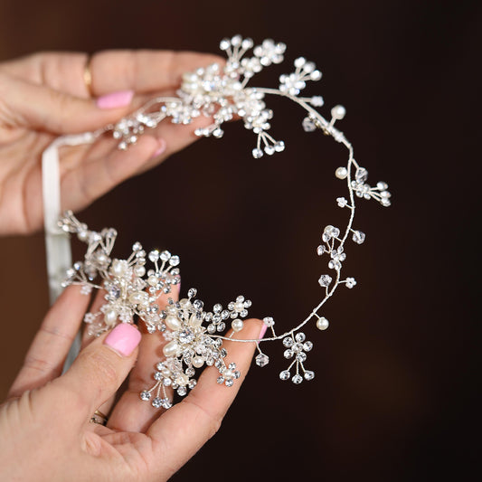 a close up of a person holding a tiara