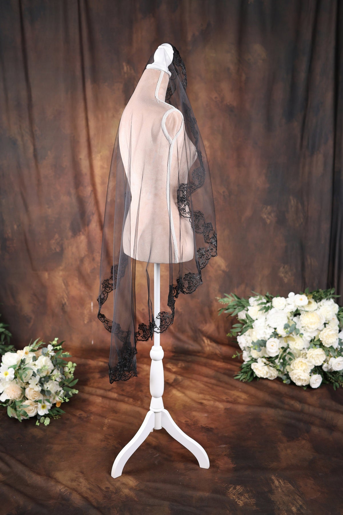 a wedding veil on a mannequin with flowers