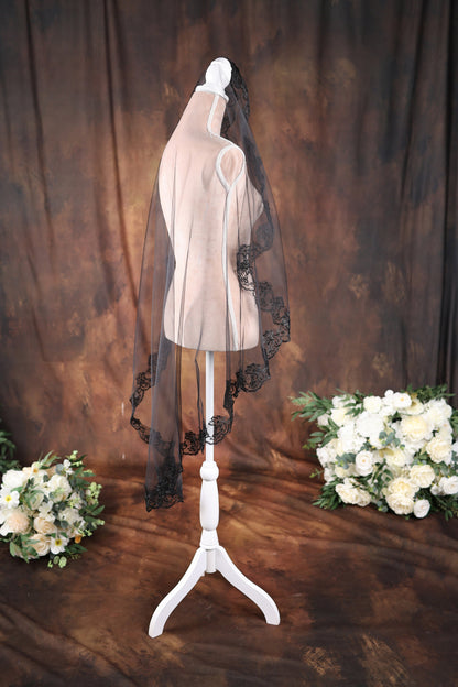a wedding veil on a mannequin with flowers