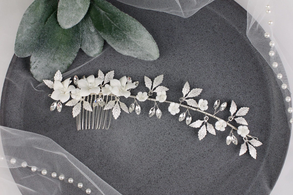a bridal hair comb with white flowers and leaves
