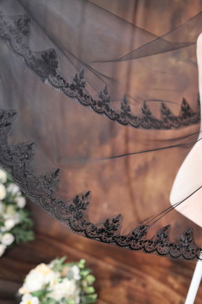 a woman is holding a veil over her shoulder