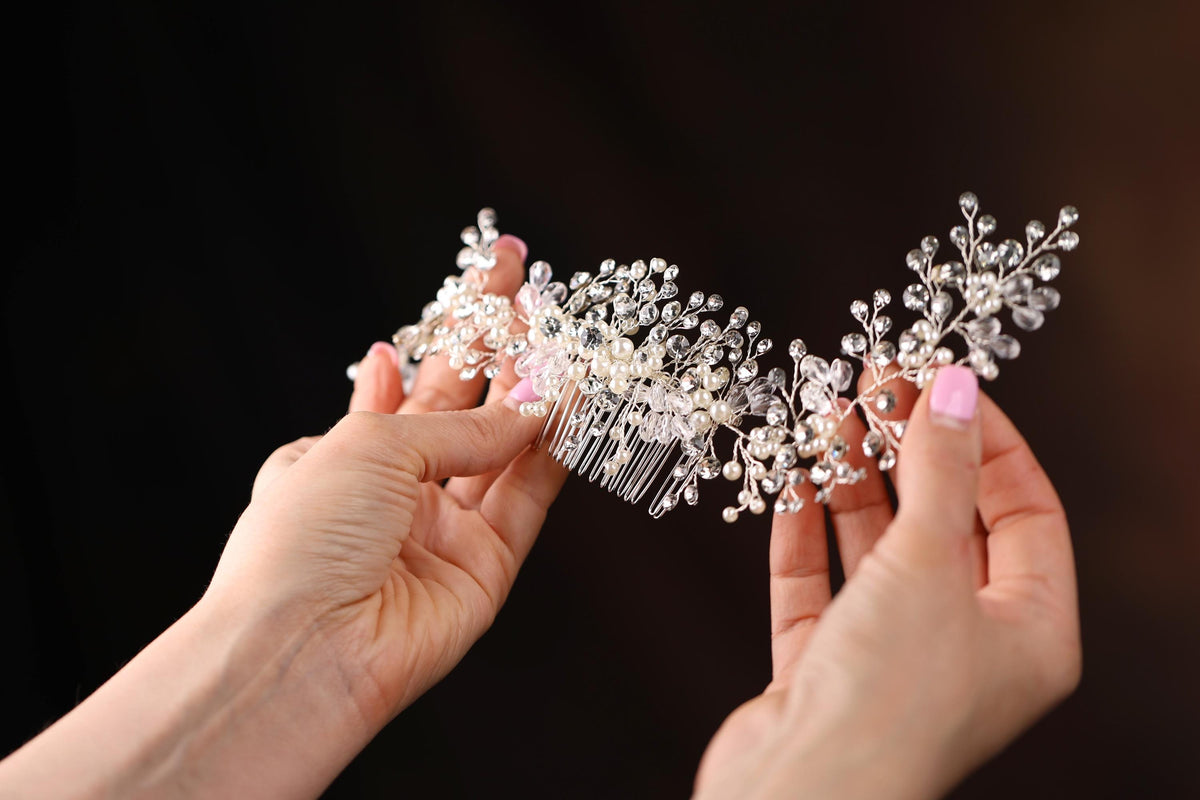 a close up of two hands holding a hair comb
