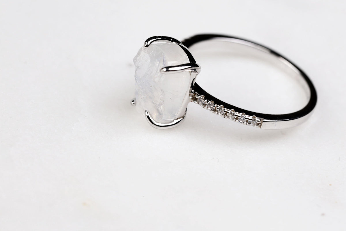 a ring with a large white stone on top of it