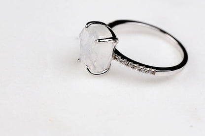 a ring with a large white stone on top of it