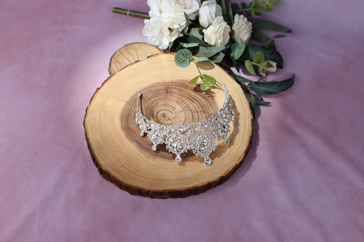 a piece of wood with a flower and a necklace on it