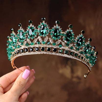 a close up of a person holding a tiara