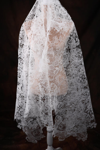 a mannequin wearing a white lace veil