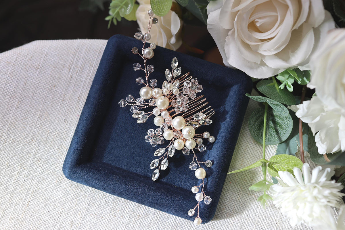 a close up of a brooch on a table with flowers