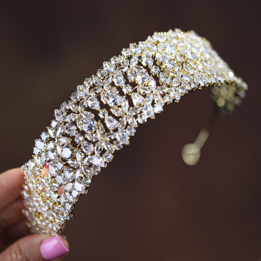 a close up of a person holding a piece of jewelry