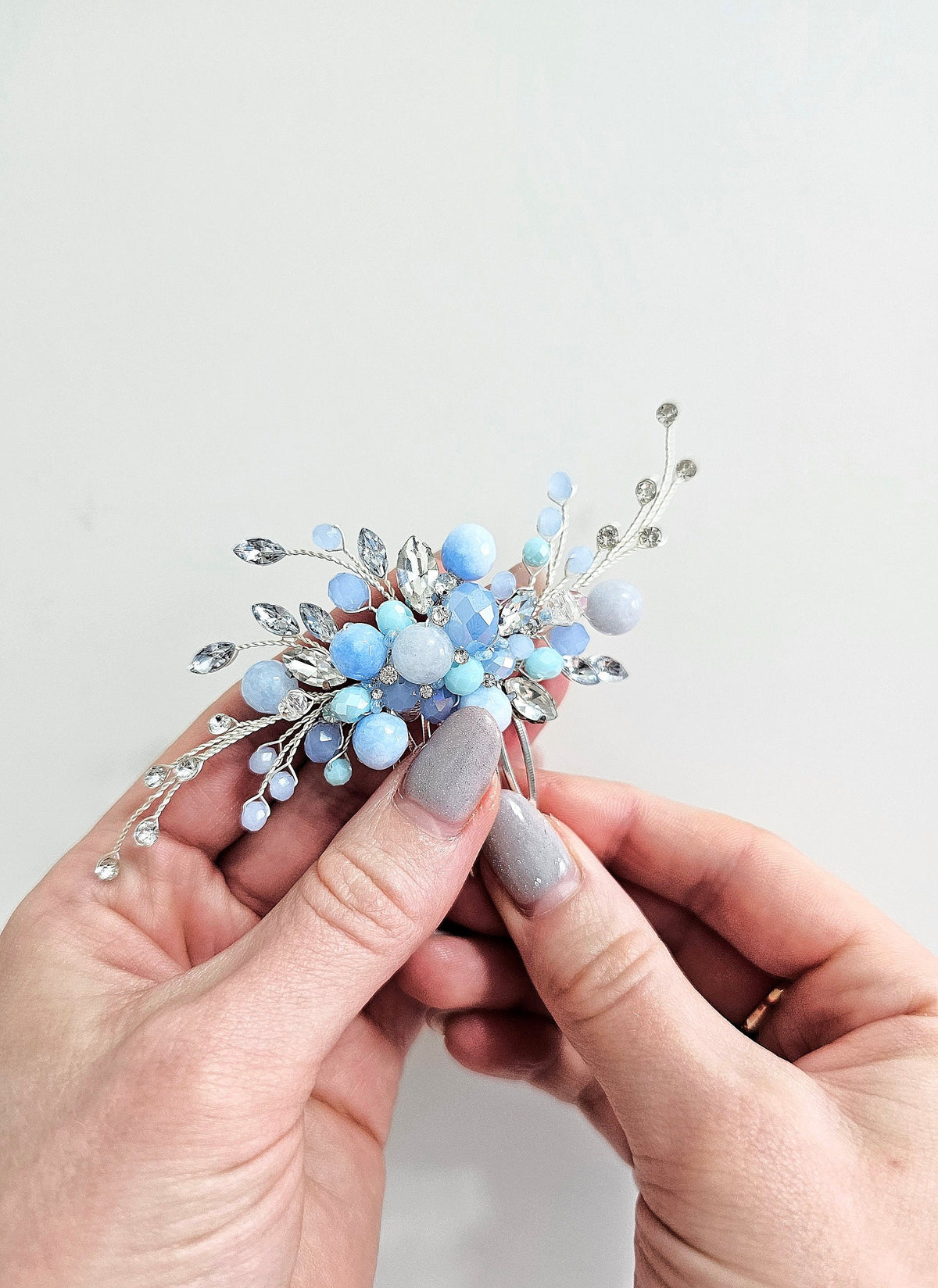 a woman is holding a small blue flower