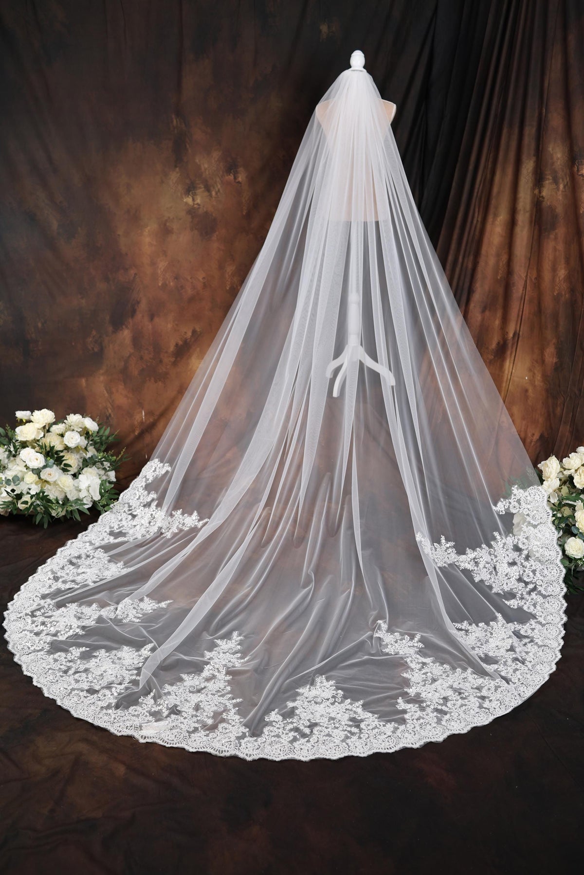 a wedding veil on a table with flowers